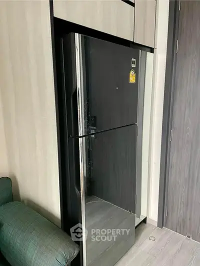 Modern kitchen with sleek black refrigerator and stylish cabinetry