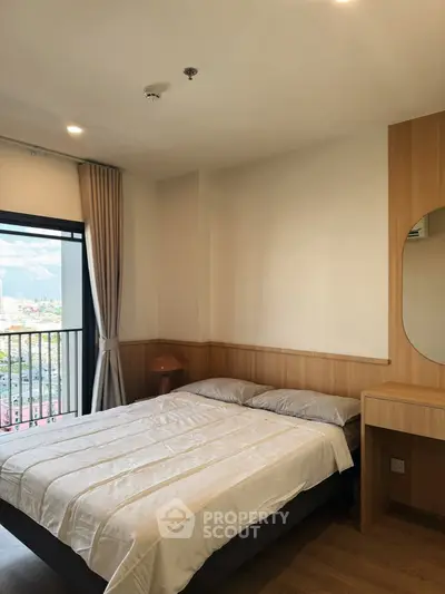Cozy bedroom with city view and modern furnishings, perfect for urban living.
