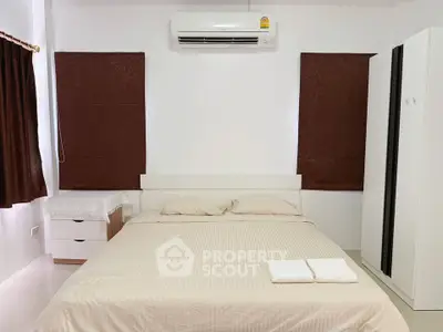 Cozy bedroom with air conditioning and modern furnishings