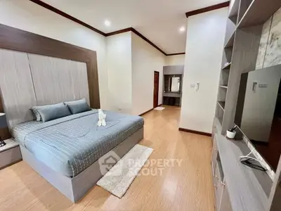 Spacious modern bedroom with elegant decor and ample storage in luxury real estate property.