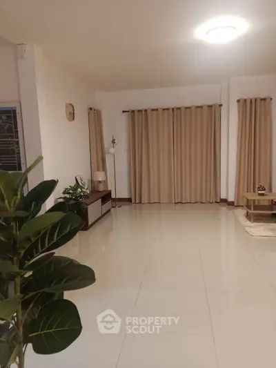 Spacious living room with elegant curtains and modern decor