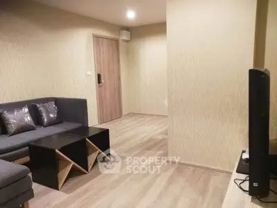 Modern living room with stylish furniture and wooden flooring in a cozy apartment.