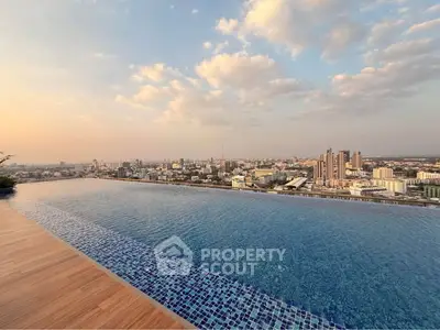 Stunning panoramic cityscape view with vibrant sky and expansive water body.