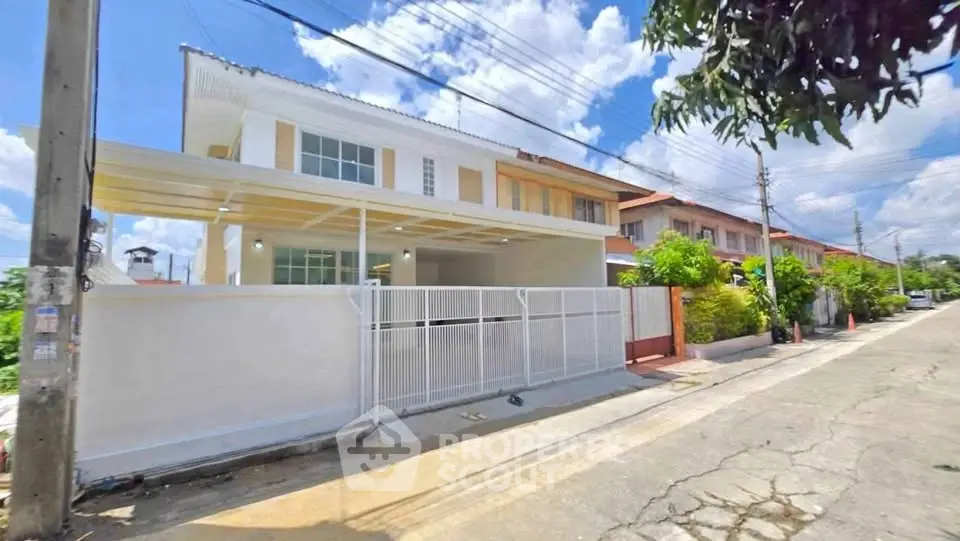 Charming two-story townhouse with a spacious driveway and modern exterior design in a serene neighborhood.