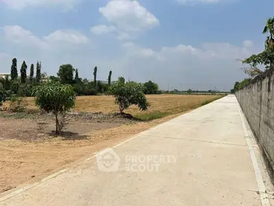 Expansive plot of land with clear skies, perfect for development opportunities.