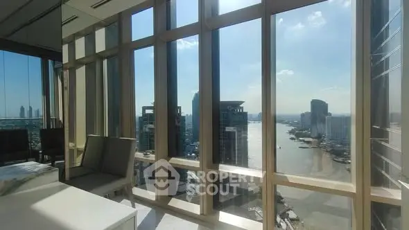 Stunning high-rise apartment with panoramic river view and floor-to-ceiling windows.