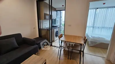 Modern apartment with open living area, kitchen, and bedroom