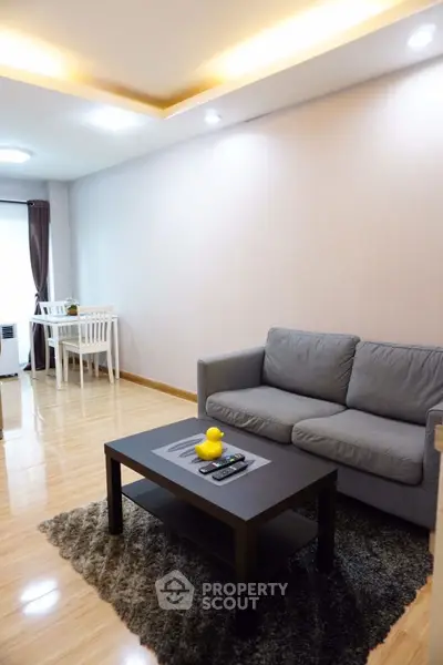 Modern living room with cozy gray sofa and stylish coffee table