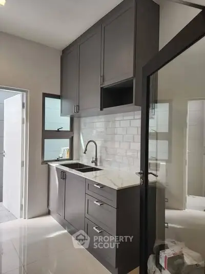 Modern kitchen with sleek cabinetry and elegant backsplash