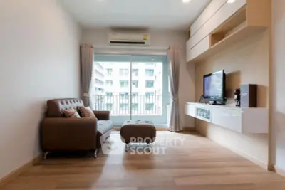 Modern living room with sleek furniture and balcony view in a stylish apartment.