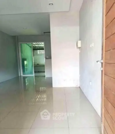 Spacious entryway with glossy tiled floors and modern design
