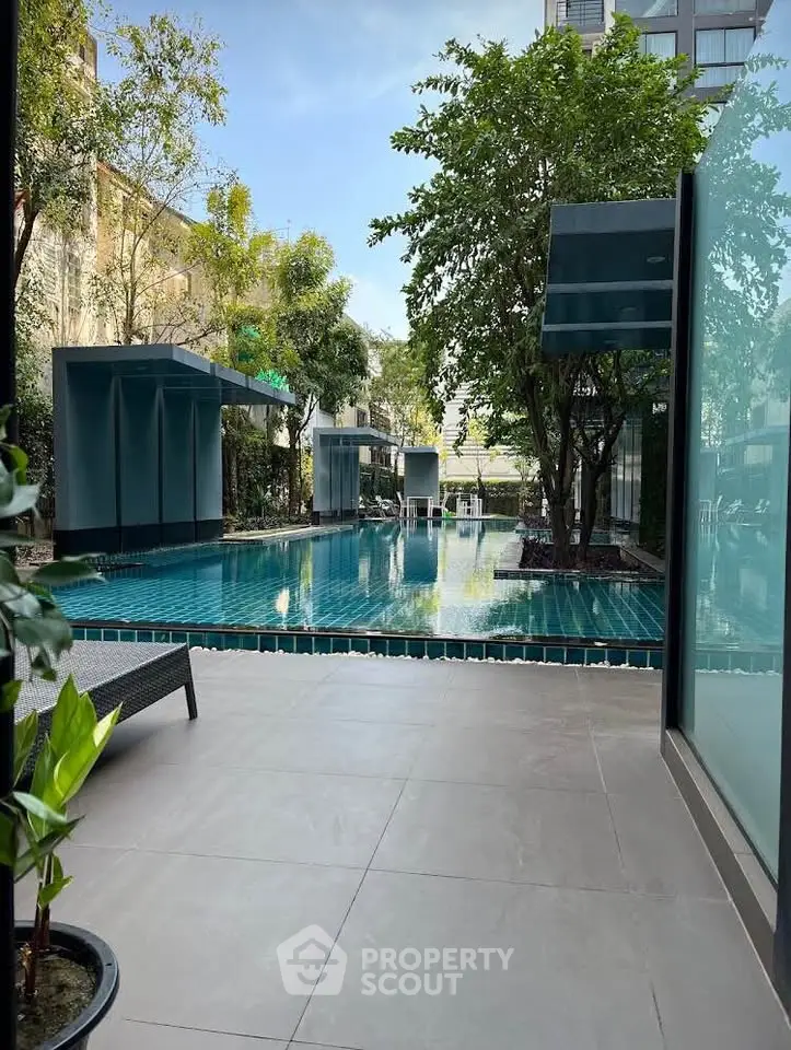 Luxurious poolside view with modern design and lush greenery, perfect for relaxation and leisure.