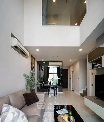 Spacious modern living room with high ceiling and elegant decor