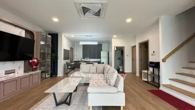 Spacious modern living room with open kitchen and stylish decor