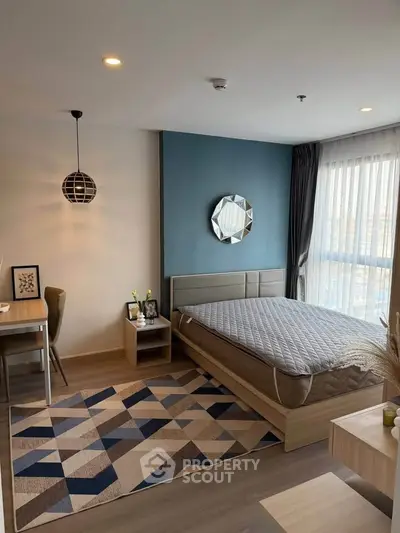 Modern bedroom with stylish decor and ample natural light