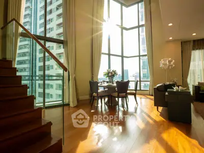 Luxurious corner unit living room with floor-to-ceiling windows and stunning city view.