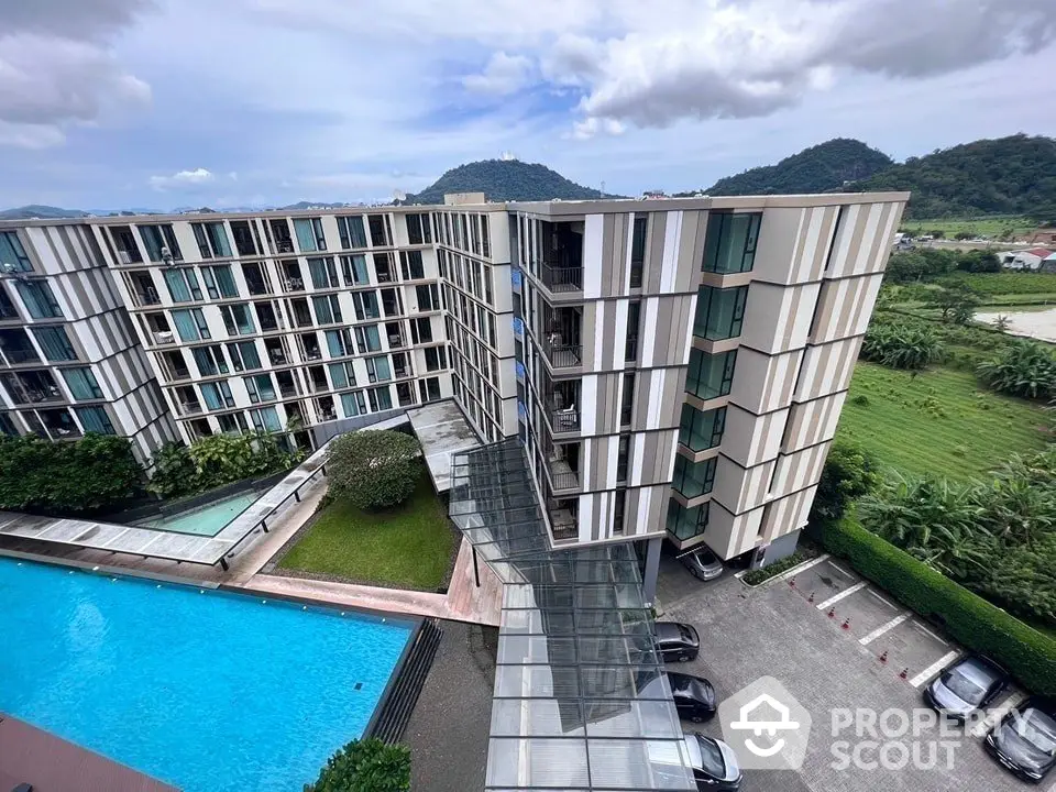 Modern apartment building with pool and scenic mountain views