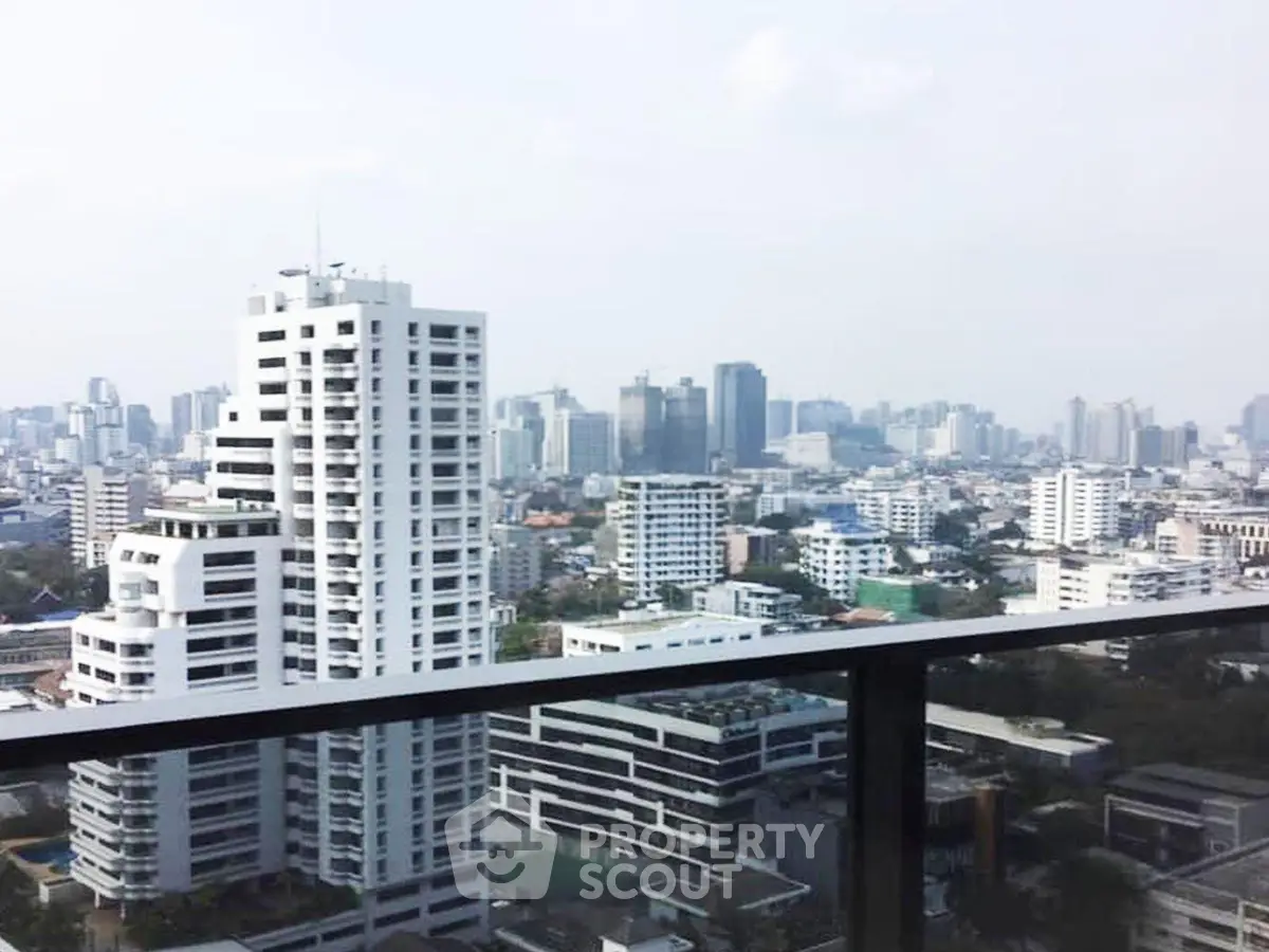 Stunning cityscape view from a high-rise balcony showcasing urban skyline.