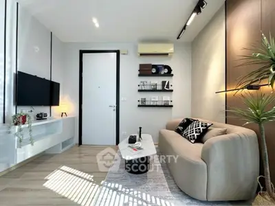 Modern living room with sleek furniture and stylish decor, featuring a cozy sofa and wall-mounted TV.