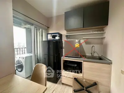 Modern compact kitchen with balcony view, featuring sleek cabinetry and appliances, ideal for urban living.