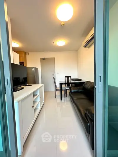 Modern living room with sleek furniture and bright lighting in a contemporary apartment.