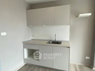 Modern minimalist kitchen with sleek cabinetry and stainless steel sink
