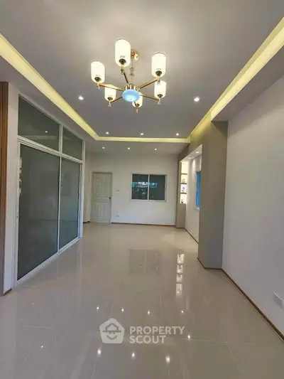 Spacious modern living room with elegant lighting and glossy tiled flooring