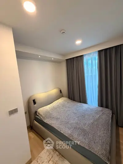 Cozy modern bedroom with stylish bed and elegant curtains