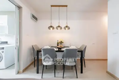 Modern dining area with elegant lighting and sleek furniture in a contemporary apartment.