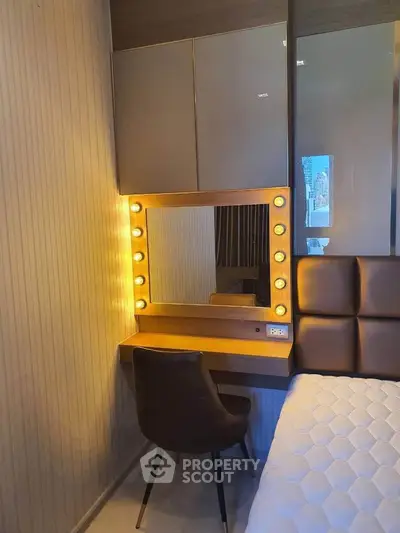 Chic bedroom with illuminated vanity and modern decor, perfect for stylish living.