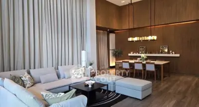 Luxurious living room with high ceilings and elegant dining area, perfect for entertaining.