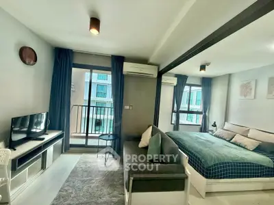Modern studio apartment with cozy living area and balcony view