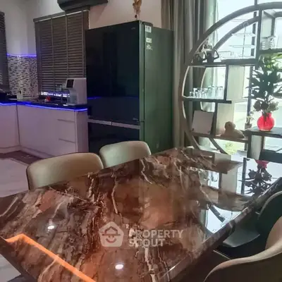 Luxurious kitchen with marble dining table and modern appliances, perfect for stylish living.