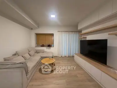 Cozy living room with modern decor and large TV setup