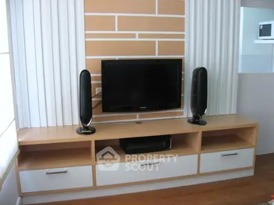 Modern living room with sleek TV setup and stylish wooden entertainment unit.
