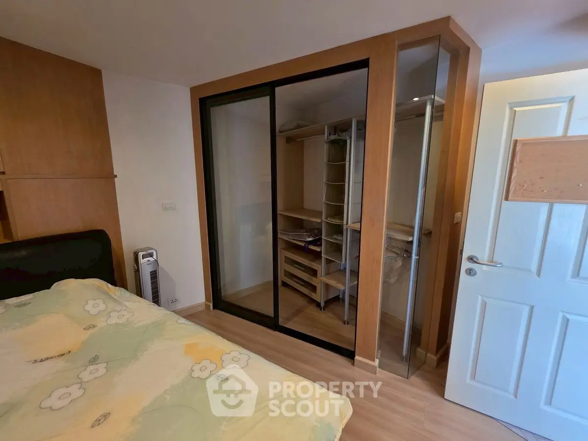 Cozy bedroom with built-in walk-in closet and modern decor