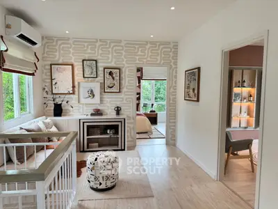Stylish modern living room with elegant decor and natural light, featuring cozy seating and artistic wall design.