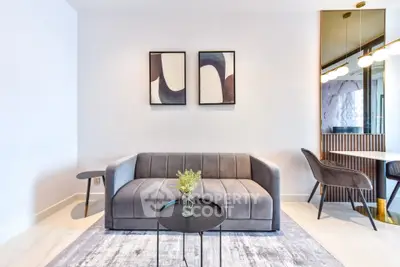 Modern living room with stylish gray sofa and abstract art, perfect for contemporary living.