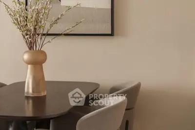 Elegant dining area with modern chairs and stylish vase on wooden table