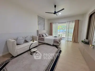 Spacious bedroom with elegant decor and large windows offering natural light