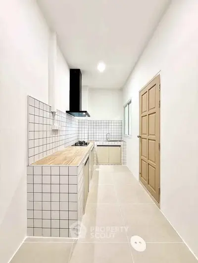 Modern minimalist kitchen with sleek closed layout and gas stove