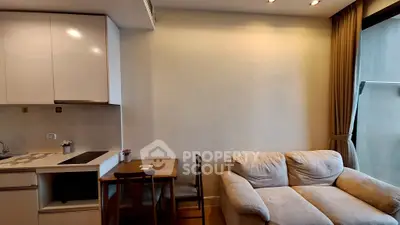 Cozy living room with compact kitchen and comfortable sofa in modern apartment