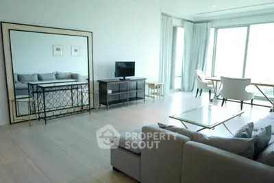 Spacious modern living room with large windows and elegant furniture