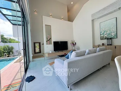 Luxurious modern living room with pool view and high ceilings