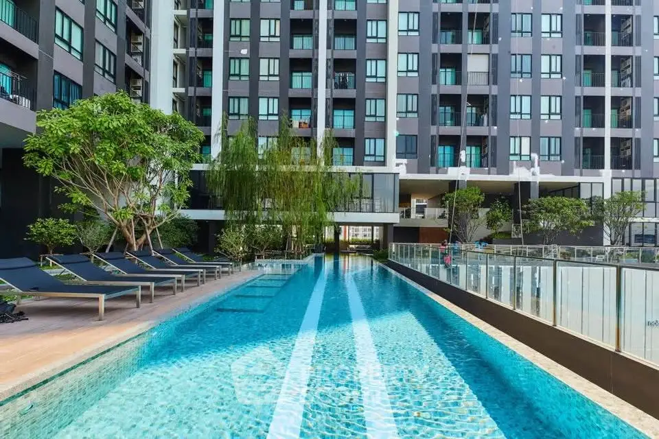 Luxurious modern apartment building with stunning pool and lush greenery