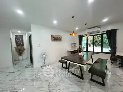 Spacious modern living room with elegant dining area and large windows