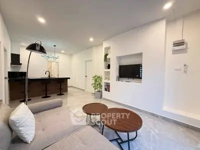 Modern open-plan living room with sleek kitchen and stylish decor