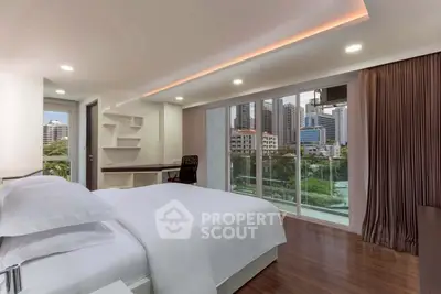 Luxurious bedroom with city view and modern decor, featuring floor-to-ceiling windows and elegant furnishings.