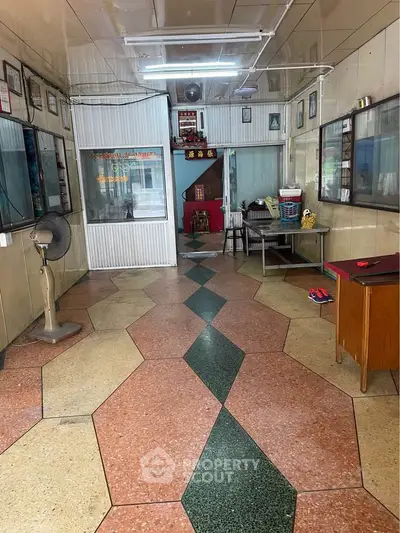 Charming vintage interior with unique geometric flooring and retro decor, perfect for creative renovation.