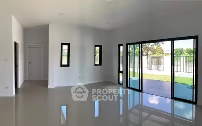 Spacious modern living room with large windows and garden view